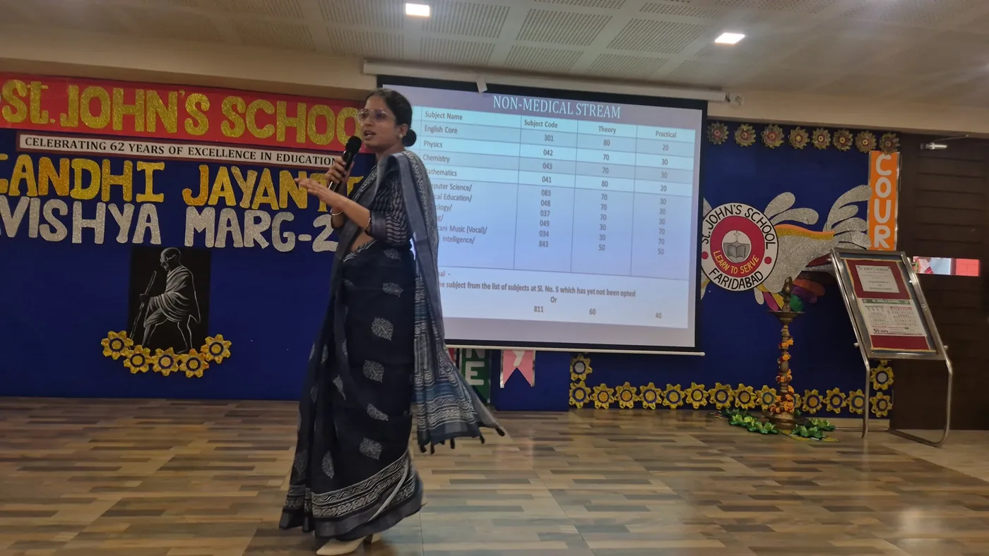 Lamhi presenting CBSE Non-Medical stream subject options to students at a St. John's School, Faridabad assembly